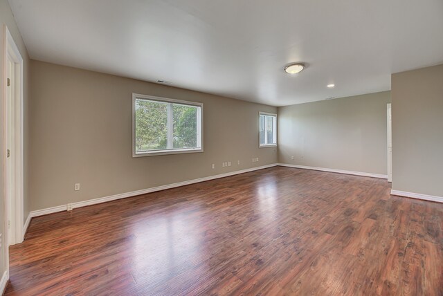 unfurnished room featuring dark wood-type flooring