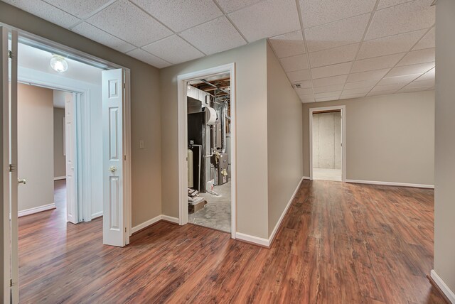 corridor featuring a drop ceiling and dark hardwood / wood-style floors