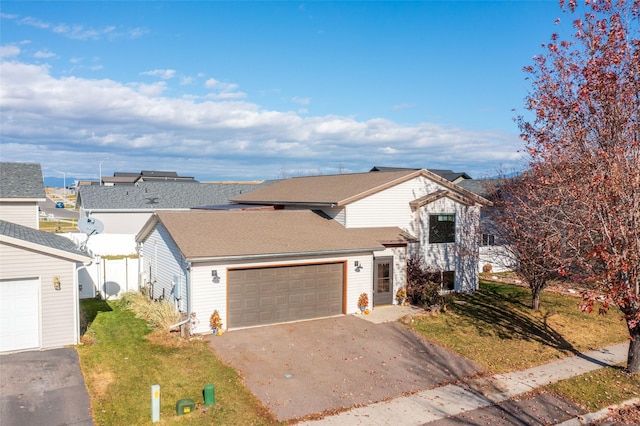 view of front of house with a front lawn and a garage