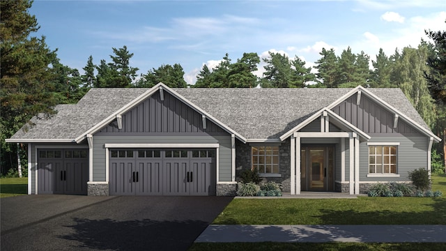 view of front of home with a garage and a front lawn