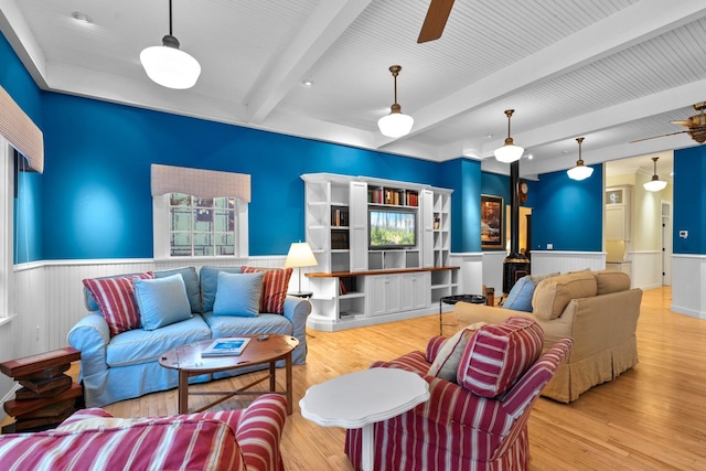 living room with beamed ceiling, ceiling fan, and hardwood / wood-style floors