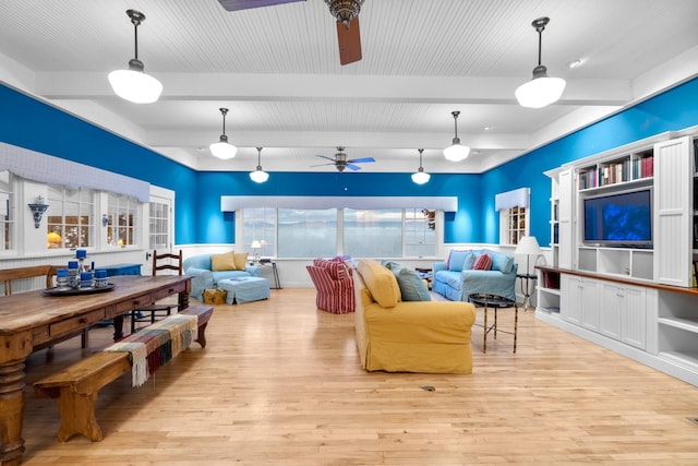 living room featuring beam ceiling, light hardwood / wood-style floors, and ceiling fan