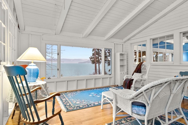 sunroom / solarium featuring vaulted ceiling with beams, wooden ceiling, and a water view