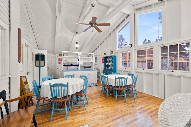 dining space featuring beam ceiling, ceiling fan, high vaulted ceiling, and light hardwood / wood-style flooring