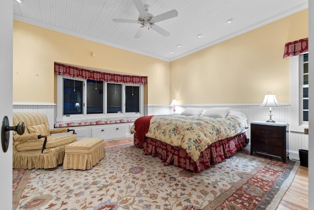 bedroom featuring ornamental molding, ceiling fan, and light wood-type flooring