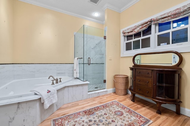 bathroom featuring hardwood / wood-style flooring, ornamental molding, and plus walk in shower