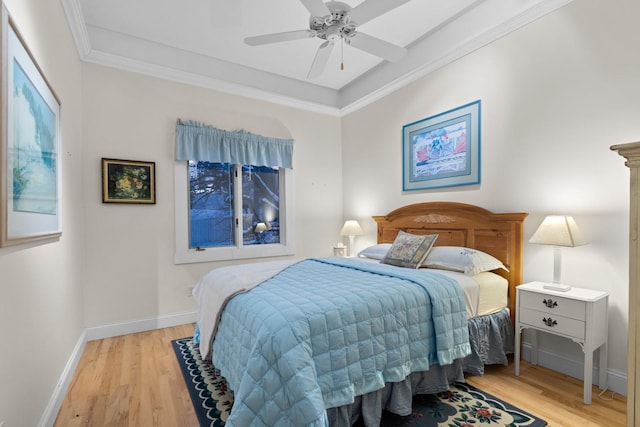 bedroom with ornamental molding, ceiling fan, and light wood-type flooring