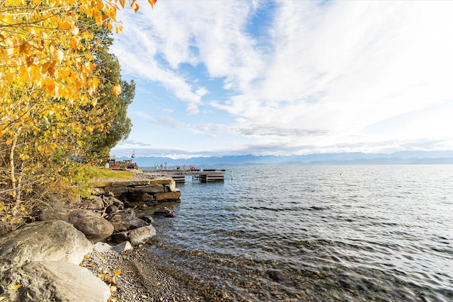 view of dock with a water and mountain view