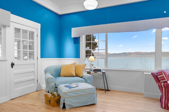 381 Lakeside Blvd, Lakeside, MT 59922 - living area with wood finished floors, a wainscoted wall, and a mountain view
