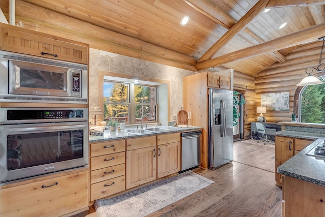 kitchen with appliances with stainless steel finishes, beamed ceiling, sink, light brown cabinets, and light hardwood / wood-style flooring