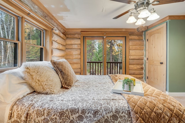 bedroom featuring log walls, access to outside, and ceiling fan