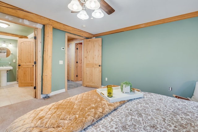 carpeted bedroom featuring ornamental molding, sink, and connected bathroom