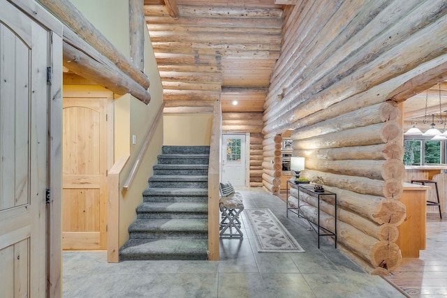 1750 Hill Meadows Rd, Whitefish, MT 59937 - staircase featuring log walls and a towering ceiling
