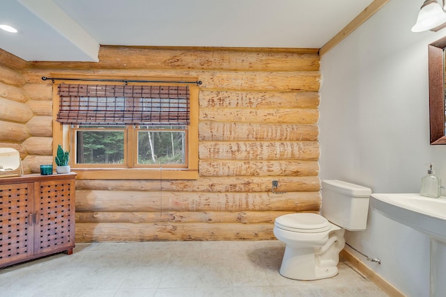 1750 Hill Meadows Rd, Whitefish, MT 59937 - bathroom featuring log walls, toilet, baseboards, and recessed lighting