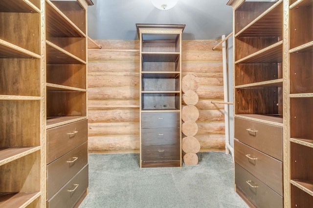 walk in closet with carpet floors