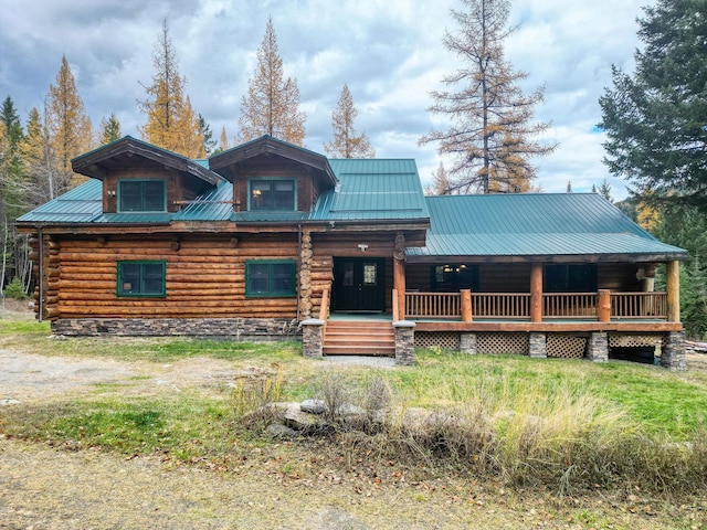 1750 Hill Meadows Rd, Whitefish, MT 59937 - log cabin featuring covered porch, metal roof, and log siding