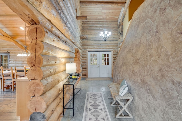 interior space featuring high vaulted ceiling, beamed ceiling, a notable chandelier, wood ceiling, and french doors