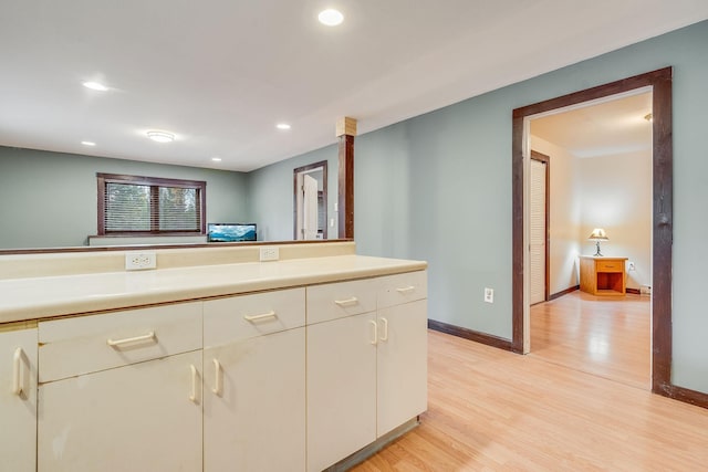 1750 Hill Meadows Rd, Whitefish, MT 59937 - kitchen featuring light countertops, light wood finished floors, recessed lighting, baseboards, and white cabinetry