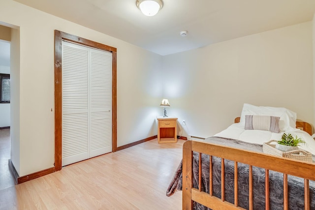 1750 Hill Meadows Rd, Whitefish, MT 59937 - bedroom with light wood finished floors, baseboards, a closet, and a baseboard radiator