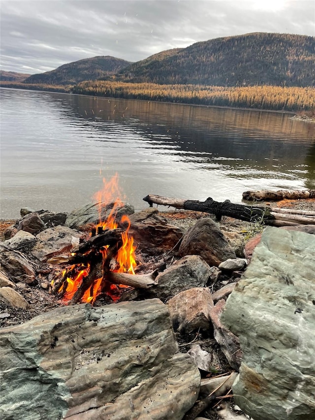 view of water feature featuring a mountain view and an outdoor fire pit