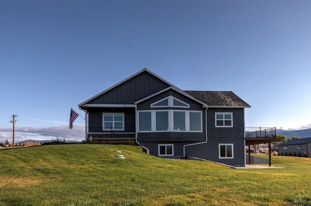 rear view of property with a lawn