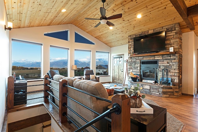 living room with a mountain view, wooden ceiling, hardwood / wood-style floors, and a fireplace