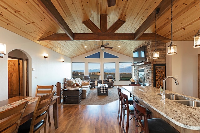 interior space featuring sink, dark wood-type flooring, vaulted ceiling with beams, and wooden ceiling