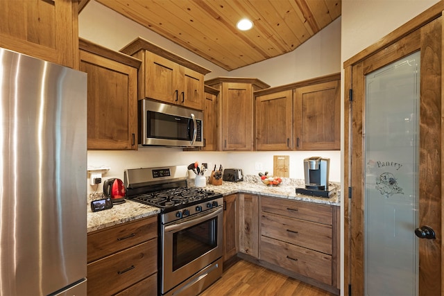 kitchen with light stone counters, stainless steel appliances, light hardwood / wood-style flooring, and wood ceiling