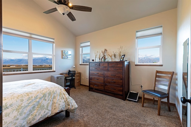 carpeted bedroom with a mountain view, vaulted ceiling, and ceiling fan