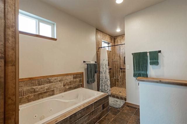 bathroom featuring shower with separate bathtub