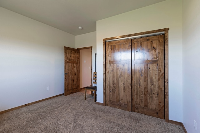 unfurnished bedroom featuring a closet and carpet floors