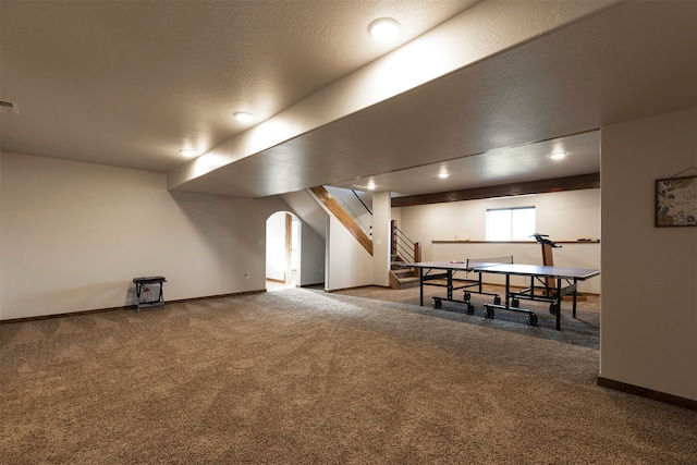 interior space featuring a textured ceiling and carpet floors