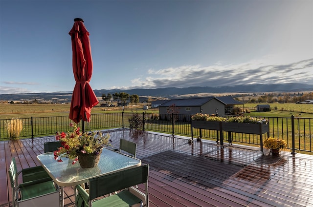 wooden terrace with a mountain view and a lawn