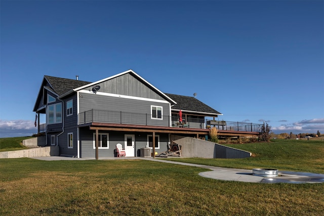 rear view of house featuring a yard, a patio area, a deck, and central AC