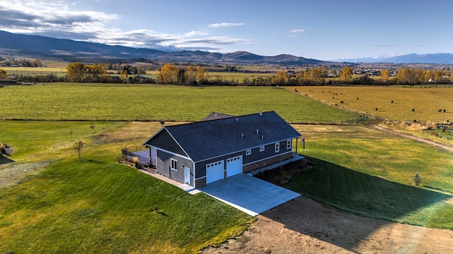 drone / aerial view with a mountain view and a rural view