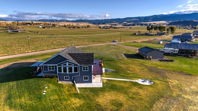 birds eye view of property with a mountain view and a rural view