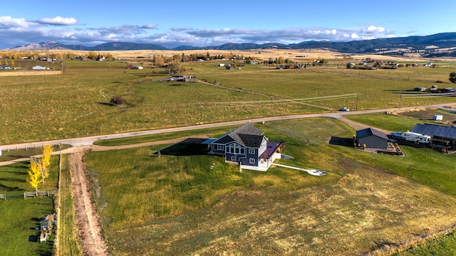 birds eye view of property featuring a mountain view and a rural view