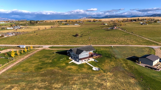 drone / aerial view featuring a mountain view and a rural view