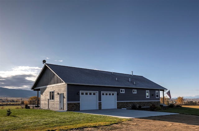 view of side of home with a garage and a lawn