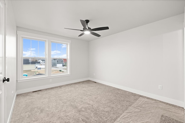 unfurnished room with ceiling fan and carpet floors