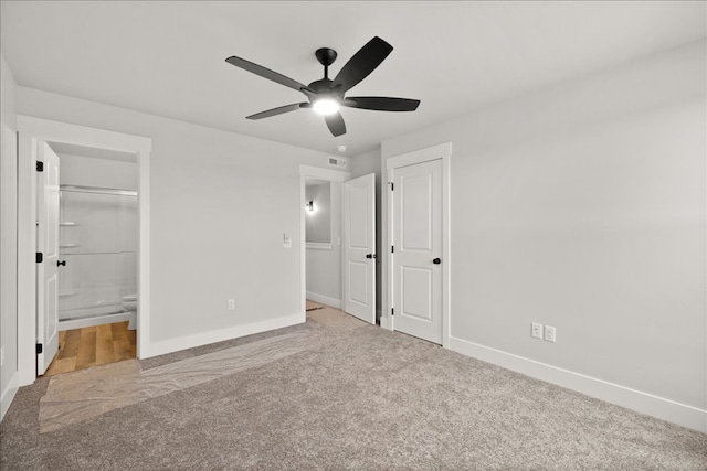 unfurnished bedroom with a closet, connected bathroom, ceiling fan, and light colored carpet