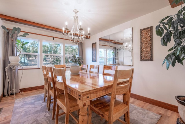 dining area featuring a chandelier and light hardwood / wood-style floors