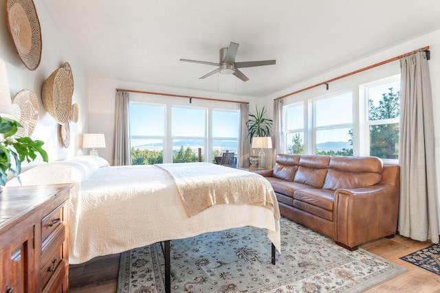 bedroom with ceiling fan and light hardwood / wood-style flooring