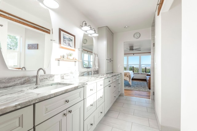 bathroom featuring tile patterned flooring, vanity, a healthy amount of sunlight, and ceiling fan