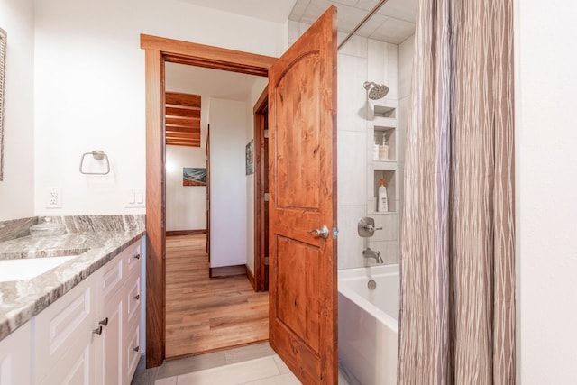 bathroom featuring vanity, wood-type flooring, and shower / bathtub combination