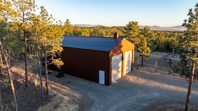 view of outbuilding with a garage and a mountain view