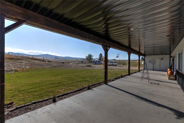 view of patio / terrace with a mountain view and a rural view