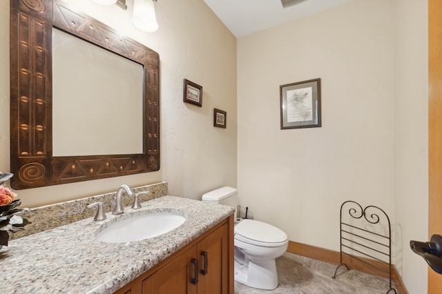 bathroom with tile patterned flooring, vanity, and toilet