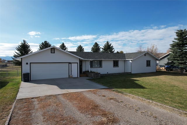 ranch-style house featuring a front yard and a garage