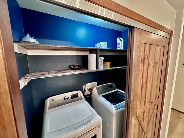 washroom featuring washer and clothes dryer